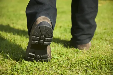 tech walking on the grass